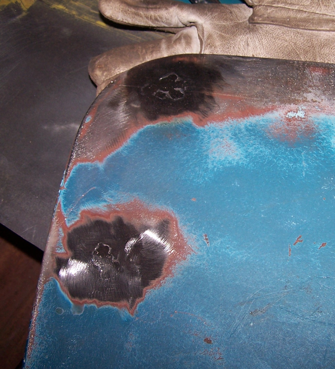Repaired rust hole in doorskin