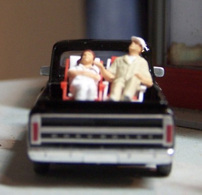 Picture of couple on lounge chairs in back of truck