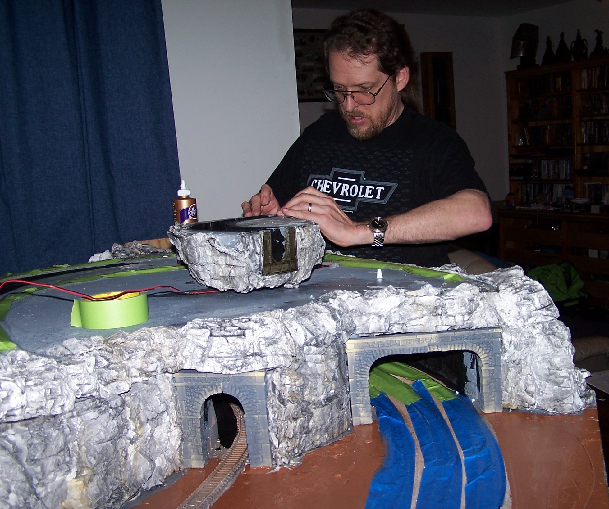 One N scale and two HO portals in place. The portal 
          for the triple track was made from 2 double track portals. Kurt cut 
          around the capstones. The funny was that the way he cut the portals, 
          the leftover pieces were able to form the single portal for the abandoned 
          track at the back.