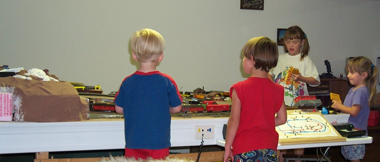 Picture of kids racing cars on layout