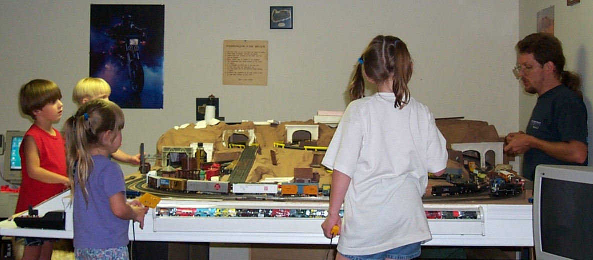Picture of kids racing cars on layout