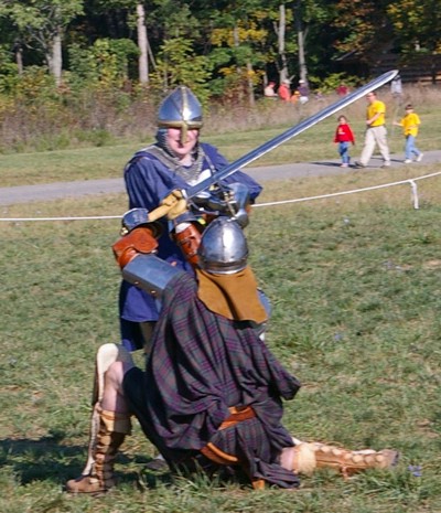 Sir Michael drives Angus Frasier to the ground.