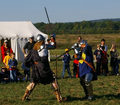 Angus Fraser and Sir Michael battle for the win as Cub Scouts watch and cheer.