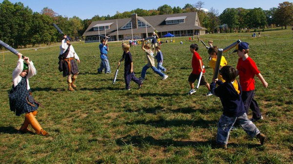 The Knights lead some Cub Scouts in practice drills with padded weapons.